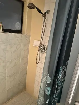 a shower with a shower head in a bathroom at Private Studio in Kissimmee