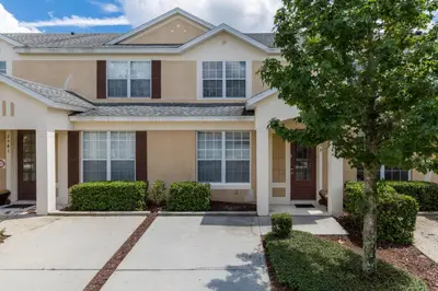 a house with a tree in front of it at Escape to Luxury in Orlando Villa6492 in Orlando