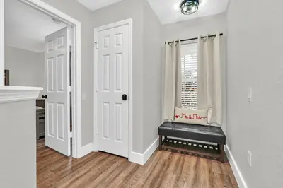 a white room with a window and a black bench at Dreamy 6 Bedroom Villa in Orlando6495 in Orlando