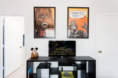 a living room with a tv and posters on the wall at Cozy 3 Bedroom Haven in Orlando6497 in Orlando