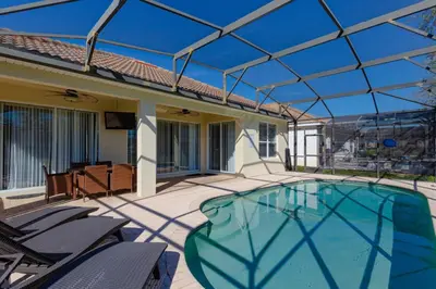a swimming pool with a glass roof on a patio at Orlando Dream Home - 4 Bed Villa6501 in Orlando