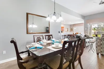 a dining room and living room with a table and chairs at Orlando Dream Home - 4 Bed Villa6501 in Orlando