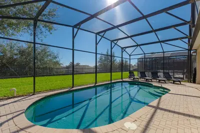 an indoor pool with a pergola and chairs at Orlando Dream Home - 4 Bed Villa6501 in Orlando