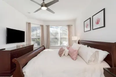 a bedroom with a large bed with a ceiling fan at Orlando Oasis: 5 Bedroom Villa6502 in Orlando