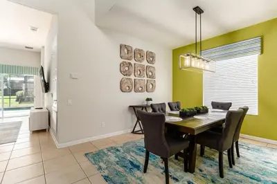 a dining room with a table and chairs at Orlando Oasis: 5 Bed Villa6504 in Orlando