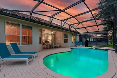 a swimming pool with a glass roof over a patio at Orlando Oasis: 5 Bed Villa6504 in Orlando