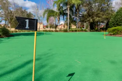 a golf course with a sign on a green field at Orlando Paradise: 3 Bed Condo6505 in Orlando