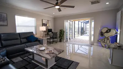 a living room with a couch and a table at Lakefront and Pool 4bed Orlando House Near Downtown 20 minutes from Attractions in Orlando
