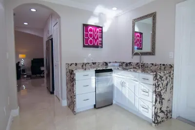 a kitchen with a counter with a sink and a mirror at Lakefront and Pool 4bed Orlando House Near Downtown 20 minutes from Attractions in Orlando