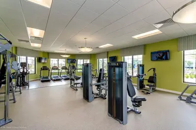 a gym with treadmills and elliptical machines at Luxury 2bd 2 bath Condo Home 254 in Kissimmee