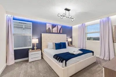 a bedroom with a bed with blue walls and a window at 2869 Epic Themed Mega Home at Storey Lake 7DB in Kissimmee