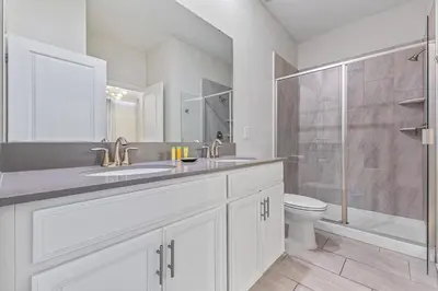a bathroom with a sink and a toilet and a shower at 2869 Epic Themed Mega Home at Storey Lake 7DB in Kissimmee