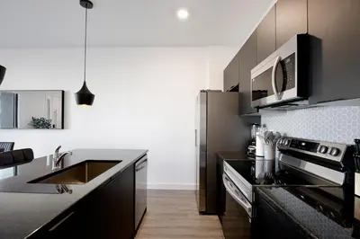 a kitchen with a sink and a stove at New great townhouse in The Hub in Kissimmee