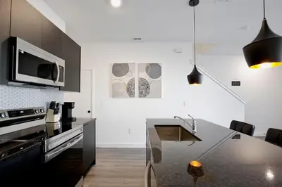 a kitchen with a black counter top and a sink at New great townhouse in The Hub in Kissimmee