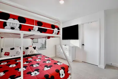 a bedroom with a red bunk bed with cows on it at New great townhouse in The Hub in Kissimmee