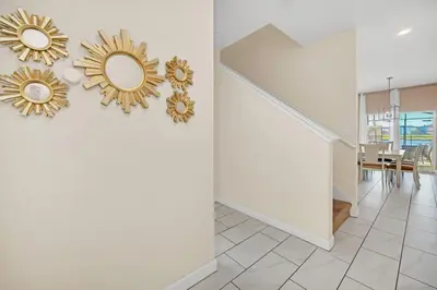 a hallway with two gold mirrors on the wall at Heated pool Lazy River Mini Golf Near Disney Resort in Kissimmee