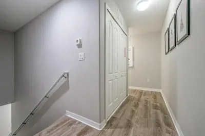 a hallway with a white door and a staircase at PP8962 - 4 Bedrooms w Pool & Resort Access in Kissimmee
