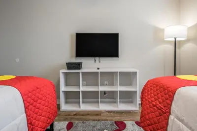 a living room with two beds and a television at PP8962 - 4 Bedrooms w Pool & Resort Access in Kissimmee