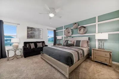 a bedroom with a large bed and a couch at The Ultimate Mansion on Solara Resort Orlando Mansion 5304 in Kissimmee