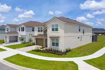 a large house with a driveway and grass at The Ultimate Mansion on Solara Resort Orlando Mansion 5304 in Kissimmee