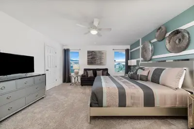 a bedroom with a bed and a flat screen tv at The Ultimate Mansion on Solara Resort Orlando Mansion 5304 in Kissimmee