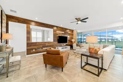 a living room with a couch and a tv at The Ultimate Mansion on Solara Resort Orlando Mansion 5304 in Kissimmee