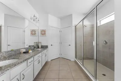 a white bathroom with a shower and a sink at New Listing - Be the First Guest 5 BR - BV468 in Kissimmee