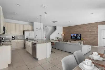 a kitchen and living room with a couch and a table at New Listing - Be the First Guest 5 BR - BV468 in Kissimmee