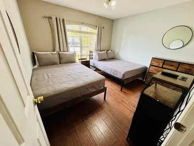 a small room with two beds and a mirror at Private Pool House With Lake View, Near All Famous Attractions!!! in Kissimmee