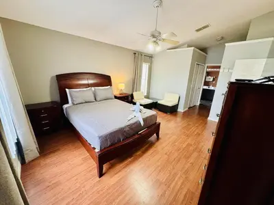 a bedroom with a bed and a wooden floor at Private Pool House With Lake View, Near All Famous Attractions!!! in Kissimmee