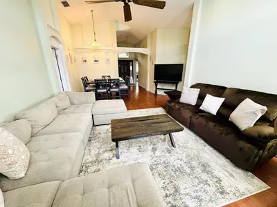 a living room with a couch and a table at Private Pool House With Lake View, Near All Famous Attractions!!! in Kissimmee