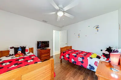 a bedroom with a bed and a ceiling fan at 514 - Make Yourself at Home on our Private Pool Deck with Spa in Orlando