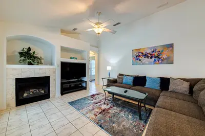a living room with a couch and a fireplace at 514 - Make Yourself at Home on our Private Pool Deck with Spa in Orlando