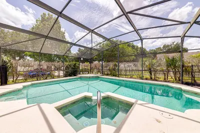 an indoor swimming pool with a glass ceiling at 514 - Make Yourself at Home on our Private Pool Deck with Spa in Orlando