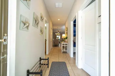 a hallway with a door and a rug at Themed 5Bd Paradise Palms Close to Disney w Pool 8951 in Kissimmee