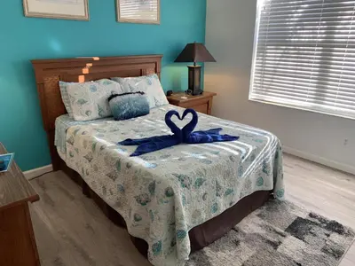 a bedroom with a bed with a ribbon on it at Beautiful 4 Bed In Prime Location in Kissimmee