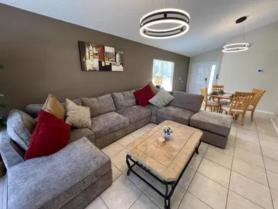 a living room with a couch and a table at Beautiful 4 Bed In Prime Location in Kissimmee