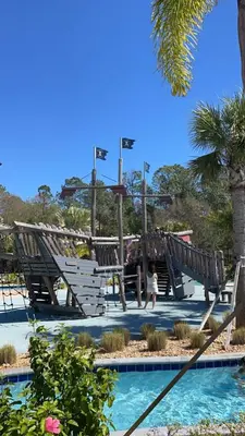 a child playing on a playground in a park at Star Wars & Harry Potter Villa with Pool & Hot Tub in Kissimmee