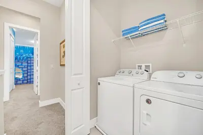 a white laundry room with a washer and dryer at NEW amazing unique dream house 5 Min to Disney in Orlando