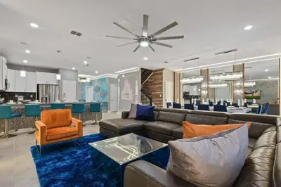 a living room with a couch and a dining room at Top Luxury Villa Storey Lake mins to Disney in Kissimmee