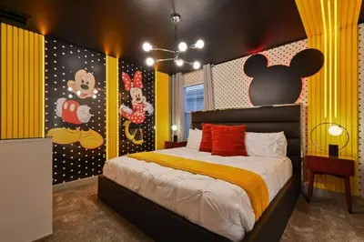 a bedroom with a bed with a mickey mouse mural at Top Luxury Villa Storey Lake mins to Disney in Kissimmee