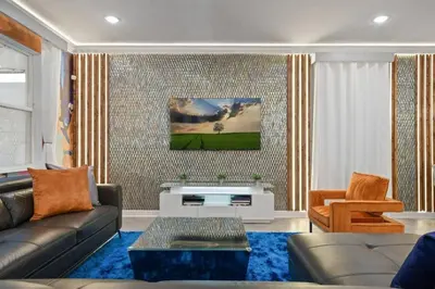 a living room with a couch and a tv at Top Luxury Villa Storey Lake mins to Disney in Kissimmee