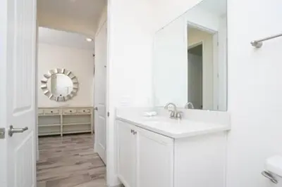 a white bathroom with a sink and a mirror at BRAND NEW Private Oasis 4 BR - Margaritaville in Orlando