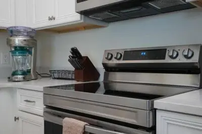 a kitchen with a stove top oven in a kitchen at BRAND NEW Private Oasis 4 BR - Margaritaville in Orlando