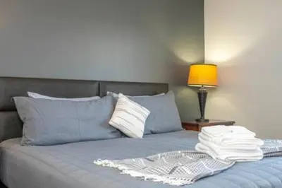 a bed with a pile of towels on top of it at Cozy 3 BR wprivate pool in Kissimmee