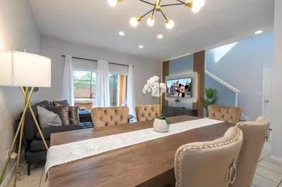 a dining room with a table and chairs at Cozy 4BR Regal Oaks close to Disney in Orlando