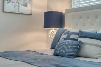 a bedroom with a bed with a lamp on it at Storey Lake Resort 5BD Private Pool Close to Disne in Kissimmee