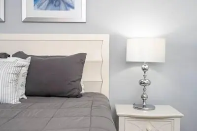 a bedroom with a bed and a table with a lamp at Gorgeous Home with pool and lake view in Kissimmee