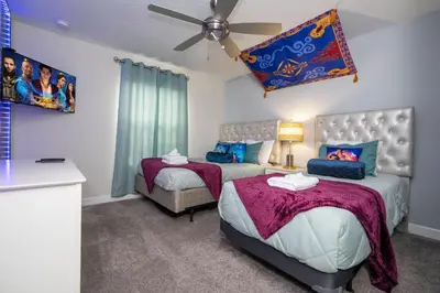 a bedroom with two beds and a ceiling fan at Gorgeous 4 BR with pool and lake view in Kissimmee