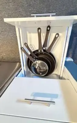 a group of utensils sitting on top of a refrigerator at Whimsical Condo 1.5M from Disney in Orlando